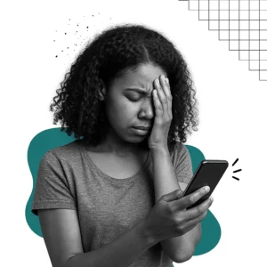 Frustrated young woman overwhelmed by smartphone notifications, holding her face in stress while looking at her phone, concept of digital distraction and attention hijacking.